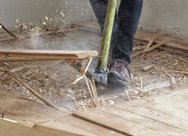 Person tearing up floors for a renovation project